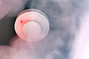 Are there regulations regarding fire alarm monitoring for different building types?